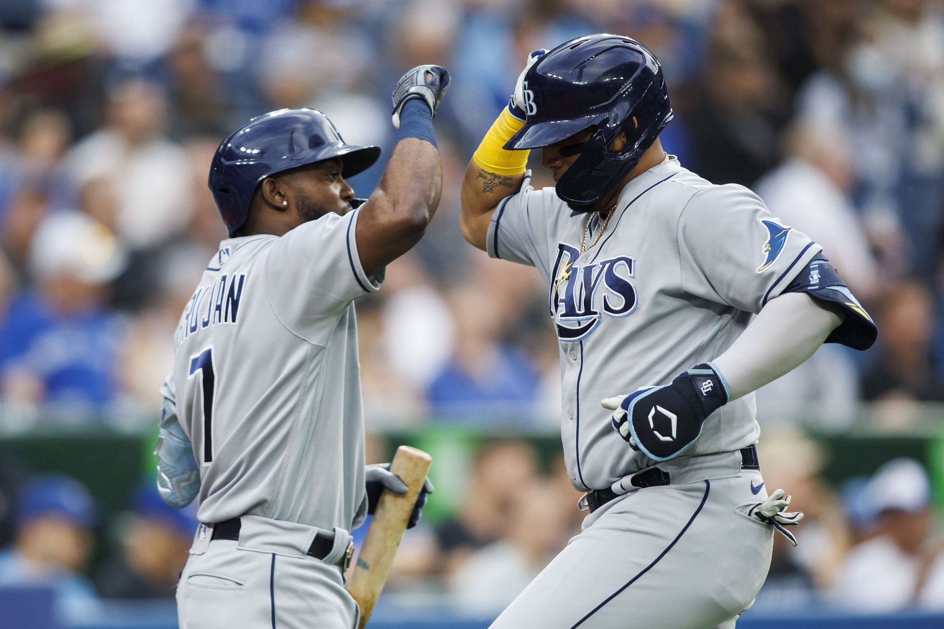 Rays players seen celebrating the lone run scored against the Blue Jays